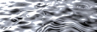 A   c l o s e - u p   o f   r i p p l i n g   b l u e   w a t e r   w i t h   a   f e w   s m a l l   b u b b l e s