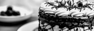 C h o c o l a t e   c a k e   a d o r n e d   w i t h   w h i p p e d   c r e a m   a n d   c h o c o l a t e   s p r i n k l e s   o n   d i s p l a y   a t   a   c o z y   b a k e r y