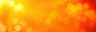 Vibrant bokeh background with warm orange and yellow tones illuminating a soft atmosphere for artistic projects