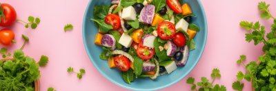 Colorful salad with fresh vegetables and herbs prepared in a bright kitchen